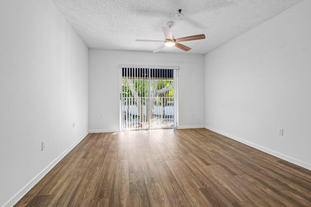 spare room with ceiling fan, dark wood-type flooring, and a textured ceiling