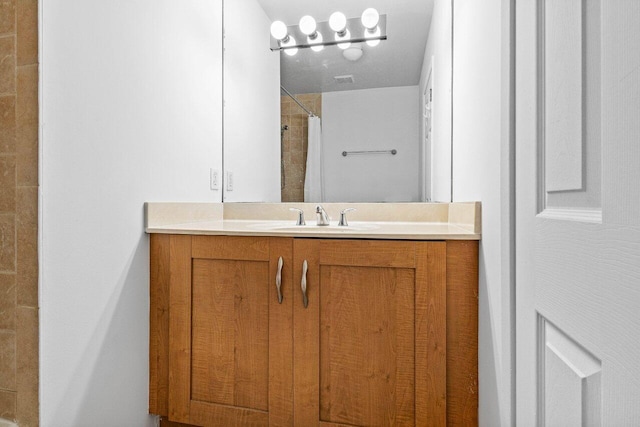 bathroom featuring vanity and walk in shower