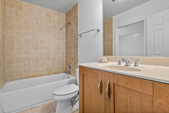 full bathroom featuring tile patterned flooring, vanity, toilet, and tiled shower / bath combo