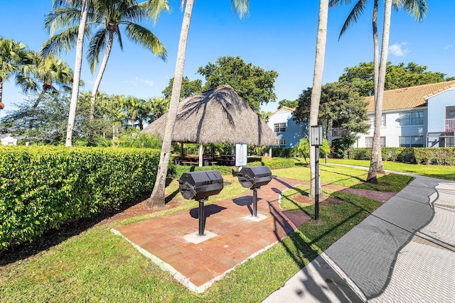 surrounding community with a gazebo and a yard