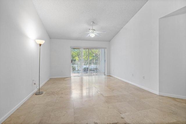 unfurnished room with ceiling fan and a textured ceiling