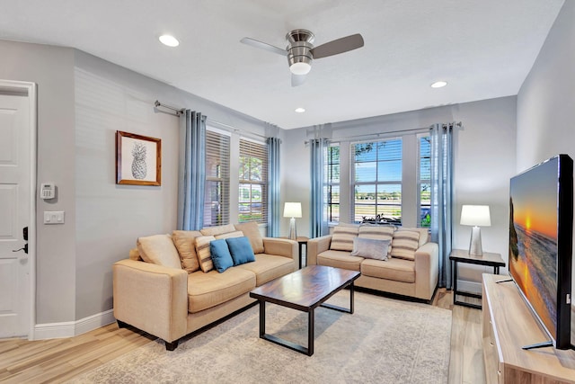 living room featuring ceiling fan and light wood-type flooring