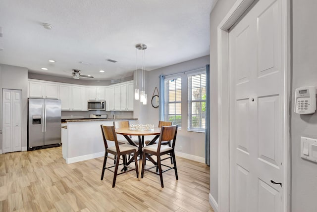 dining room with light wood-type flooring