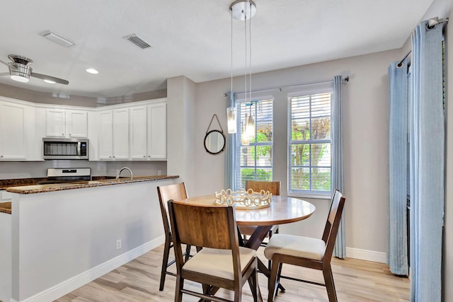 dining room featuring sink and light wood-type flooring