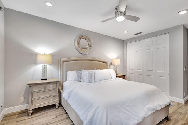 bedroom with ceiling fan, a closet, and light hardwood / wood-style floors