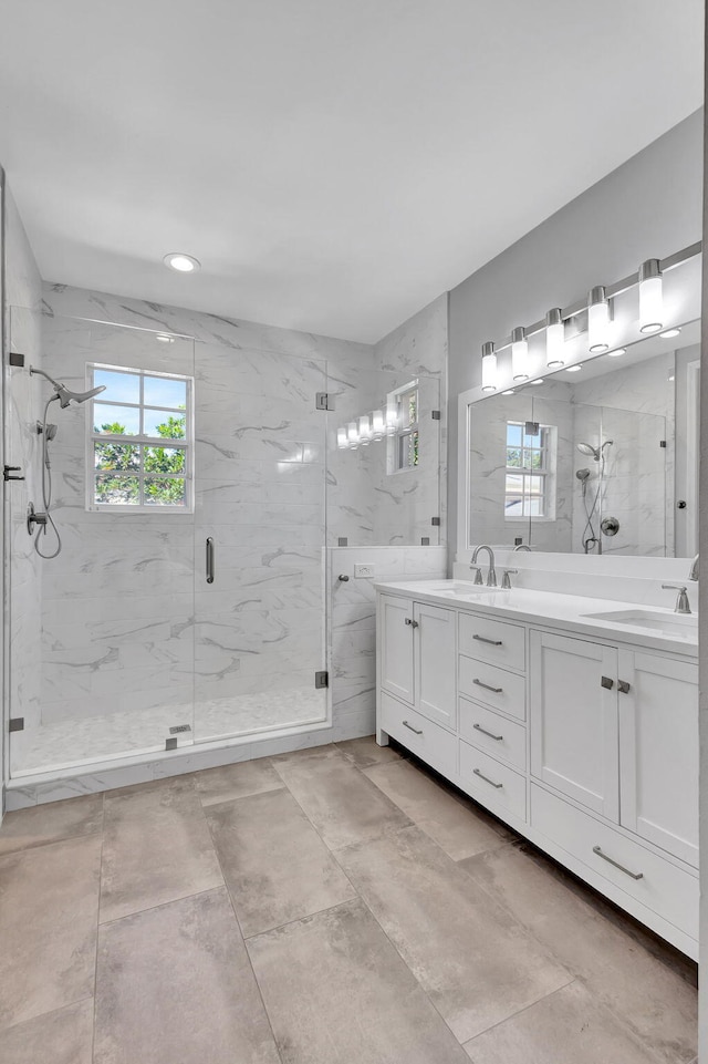 bathroom with vanity and a shower with door