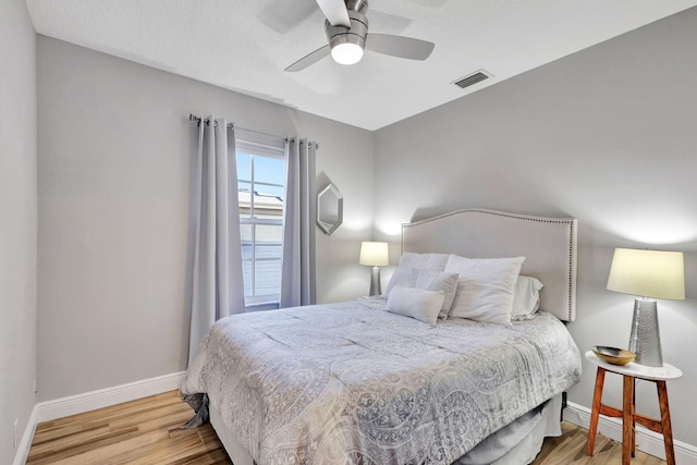 bedroom featuring ceiling fan and hardwood / wood-style flooring