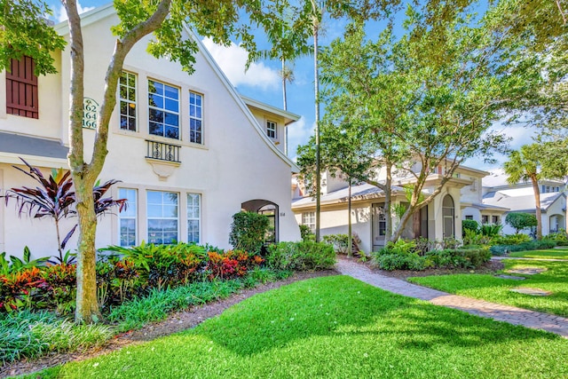 mediterranean / spanish house featuring a front yard