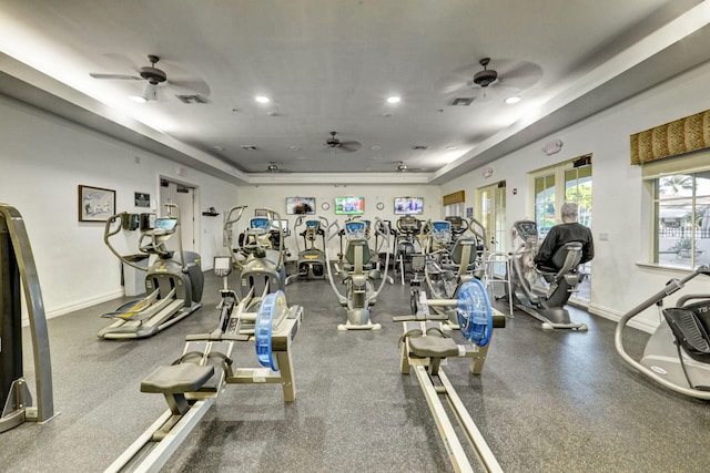 workout area featuring a tray ceiling