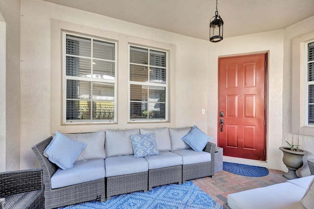 view of exterior entry featuring a patio area and an outdoor living space