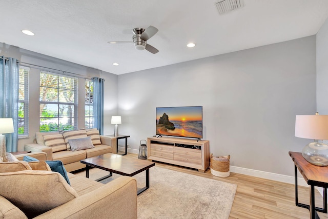 living room with ceiling fan and light hardwood / wood-style floors