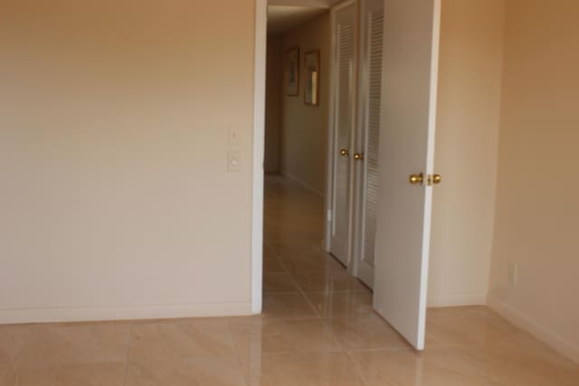 corridor with light tile patterned flooring