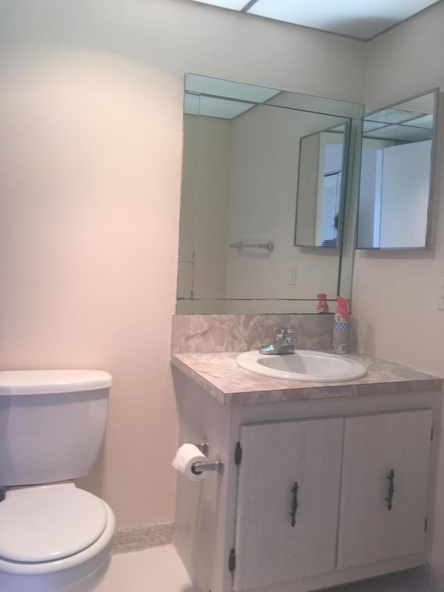 bathroom featuring vanity, toilet, and tile patterned floors