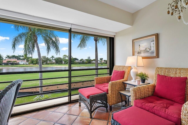 sunroom featuring a water view