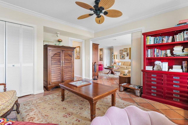 living room featuring ceiling fan, ornamental molding, baseboards, and tile patterned flooring