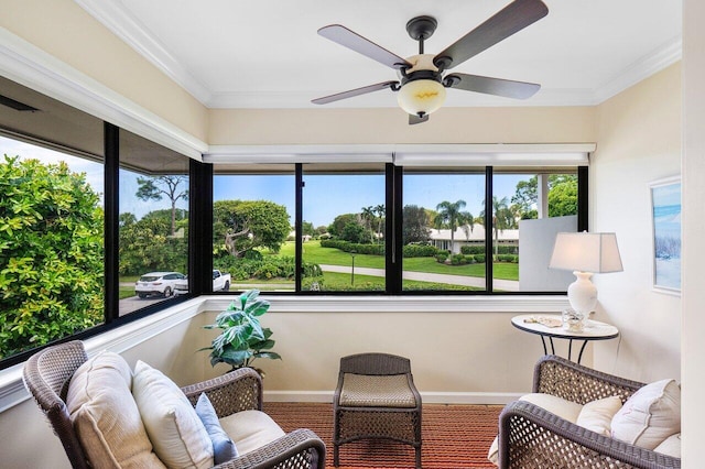 sunroom / solarium featuring a ceiling fan