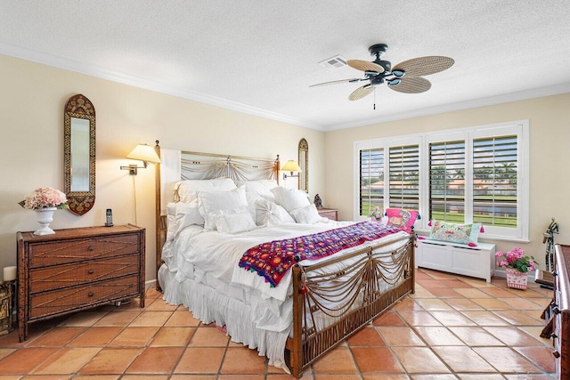 bedroom featuring ceiling fan, light tile patterned floors, a textured ceiling, and ornamental molding