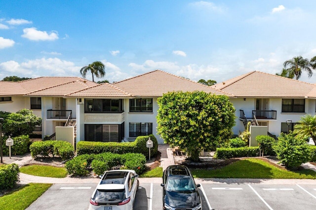 view of property featuring uncovered parking
