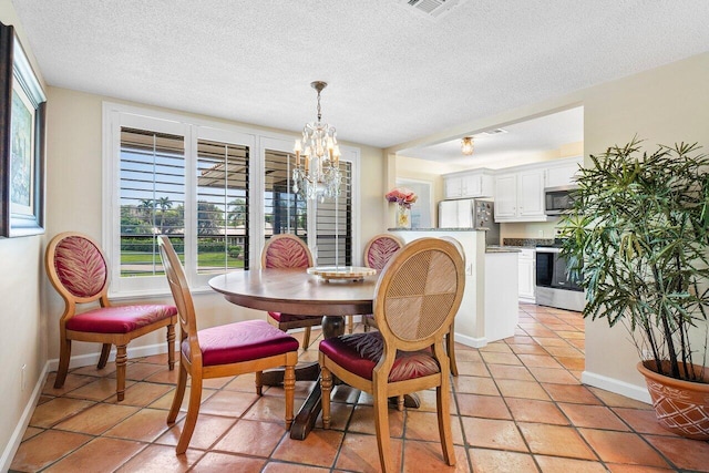 dining space featuring a textured ceiling, light tile patterned floors, a chandelier, and a healthy amount of sunlight