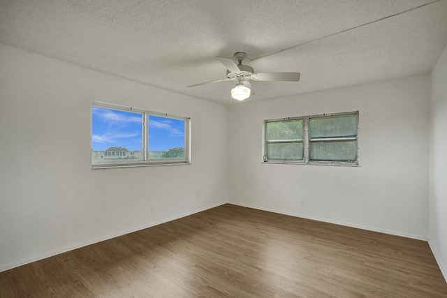 spare room with hardwood / wood-style flooring and a wealth of natural light