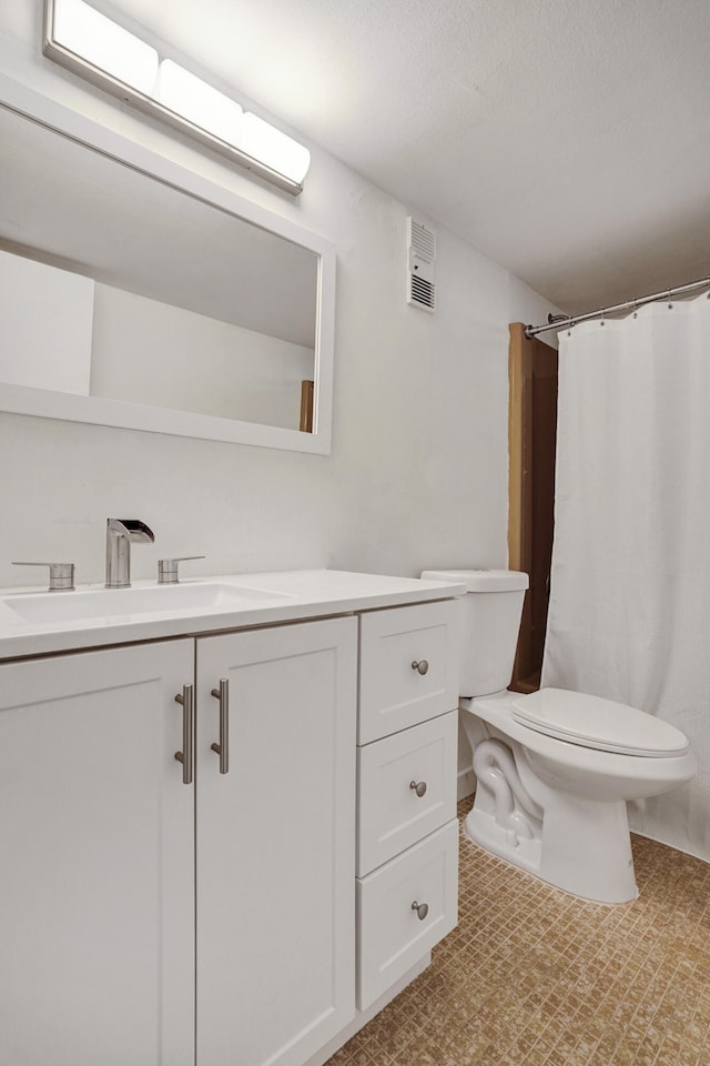 bathroom with toilet, a textured ceiling, walk in shower, and vanity