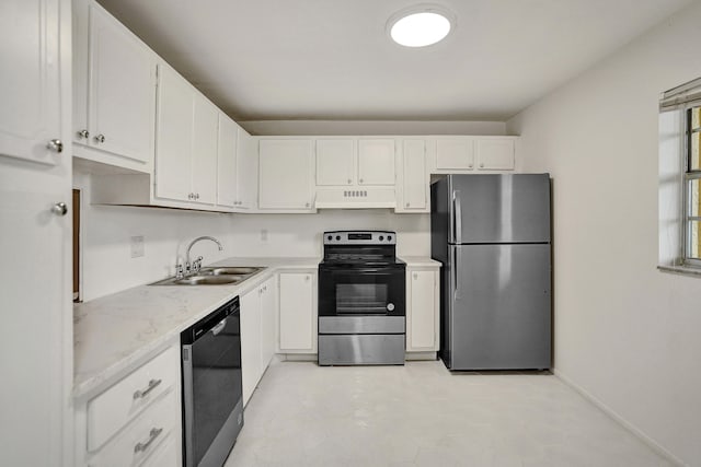 kitchen featuring premium range hood, white cabinetry, stainless steel appliances, and sink