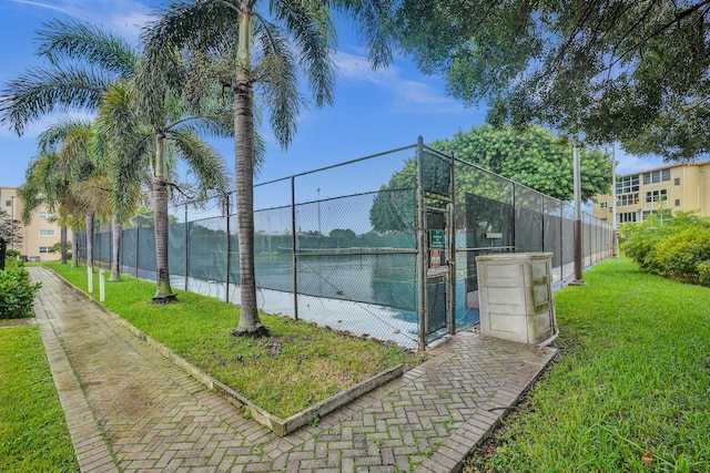 view of sport court featuring a yard