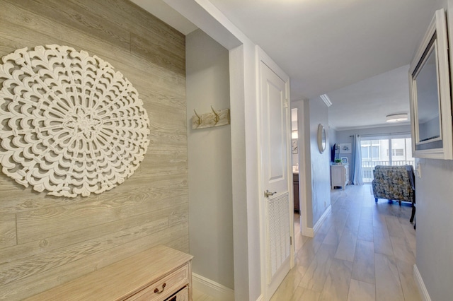 hall featuring wooden walls and hardwood / wood-style flooring