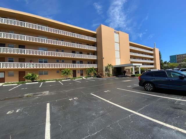 219 NE 14th Ave Unit 407, Hallandale Beach, FL 33009 - view of building exterior with uncovered parking