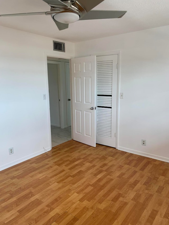 unfurnished bedroom with ceiling fan and light hardwood / wood-style floors