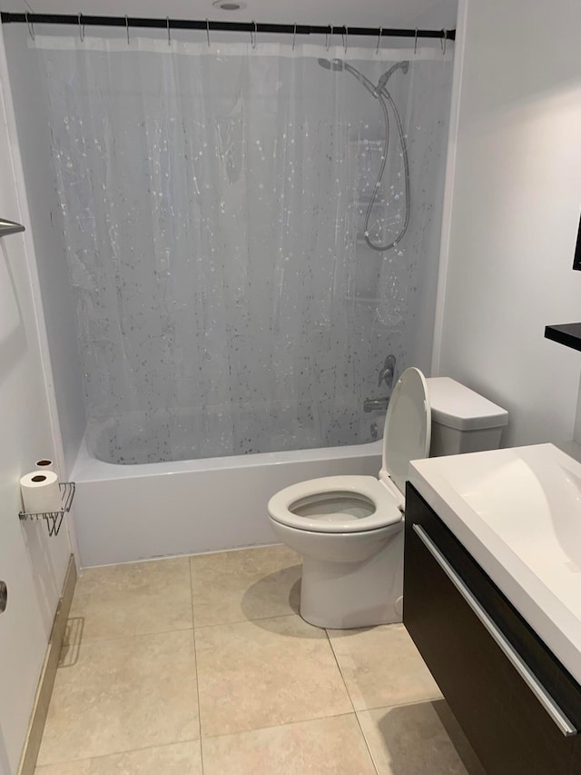 bathroom featuring toilet, vanity, and tile patterned floors