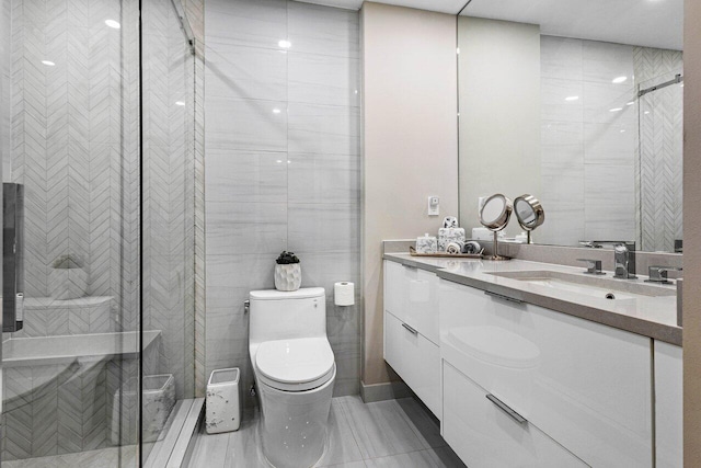 bathroom featuring toilet, tile walls, a shower with shower door, and vanity