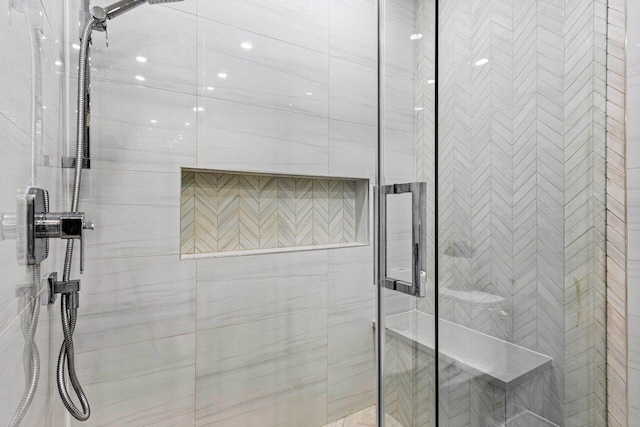 bathroom featuring a shower with shower door