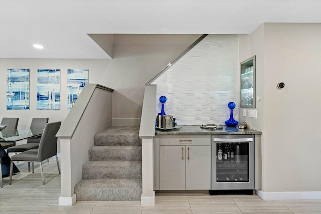 bar featuring wine cooler and light tile patterned flooring