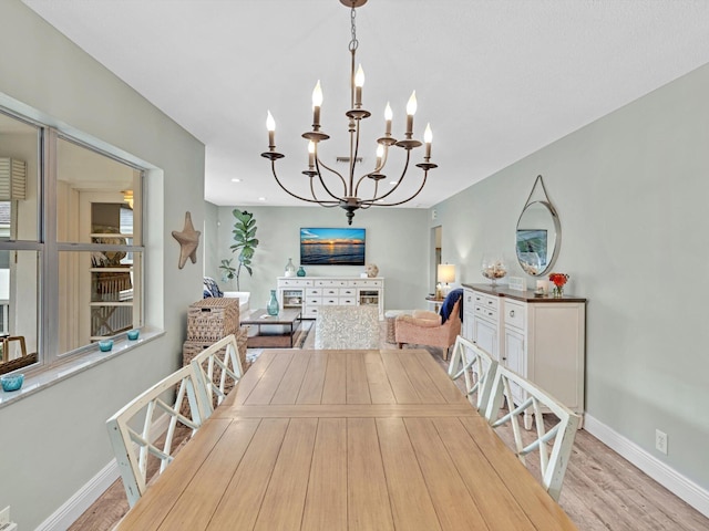 dining room featuring light hardwood / wood-style floors and a notable chandelier