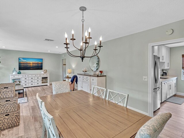 1015 Ingraham Ave Unit 6, Delray Beach, FL 33483 - dining room with a notable chandelier, baseboards, recessed lighting, and light wood-style floors