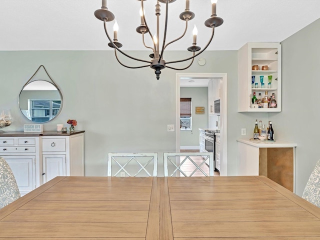 unfurnished dining area featuring an inviting chandelier