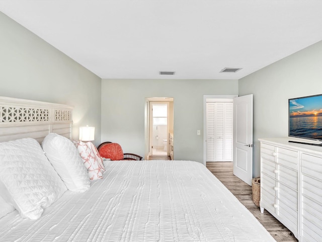 bedroom with dark hardwood / wood-style flooring