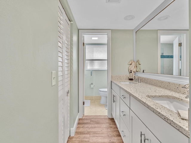 1015 Ingraham Ave Unit 6, Delray Beach, FL 33483 - bathroom featuring double vanity, wood finished floors, toilet, and a sink