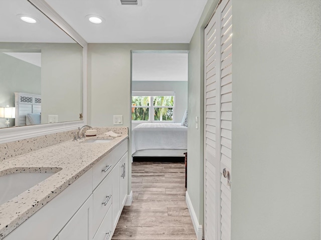 bathroom with hardwood / wood-style flooring and vanity