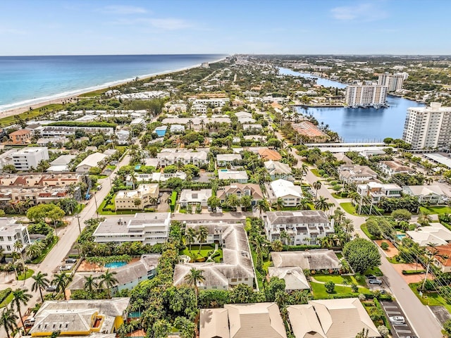 drone / aerial view with a water view and a view of the beach