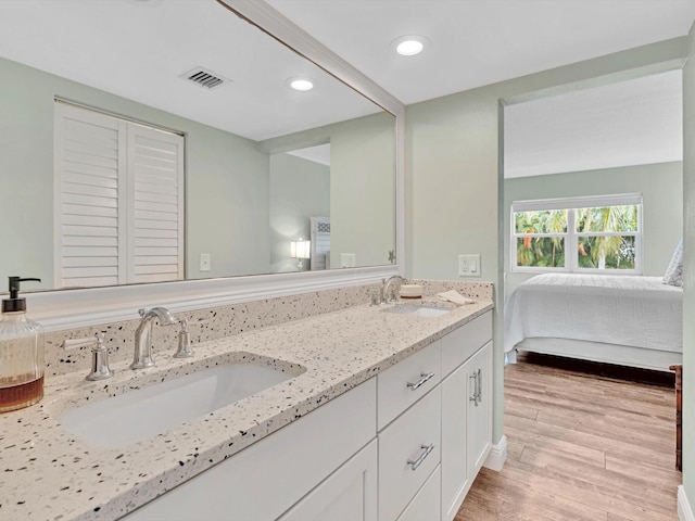 bathroom with hardwood / wood-style flooring and vanity