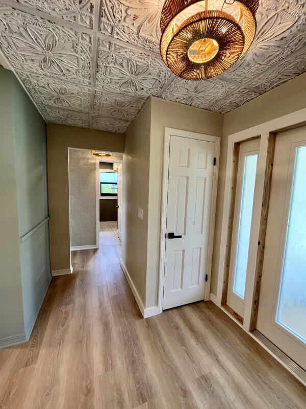 corridor with light wood-type flooring