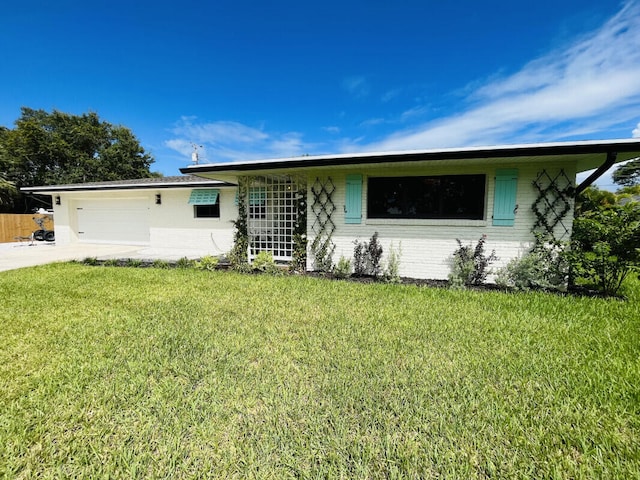 single story home featuring a front yard and a garage