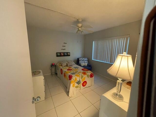 tiled bedroom with ceiling fan