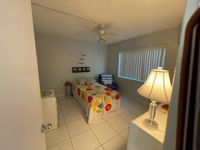 bedroom with baseboards, tile patterned floors, and a ceiling fan