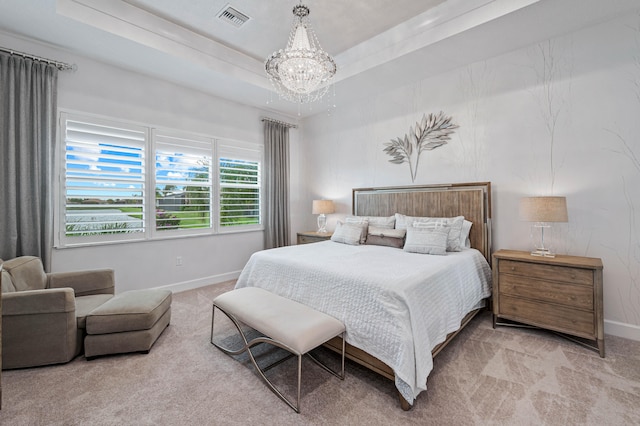 bedroom featuring light colored carpet, an inviting chandelier, and a raised ceiling