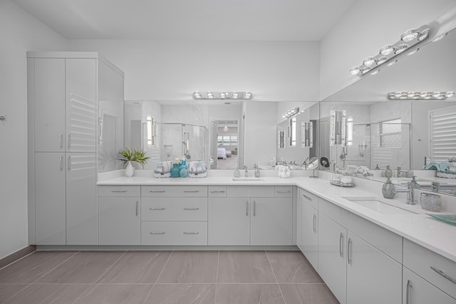 bathroom with vanity, a shower with shower door, and tile patterned floors