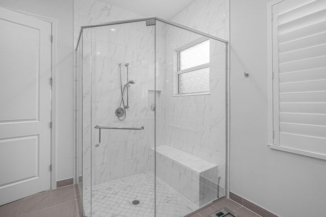 bathroom featuring tile patterned floors and an enclosed shower