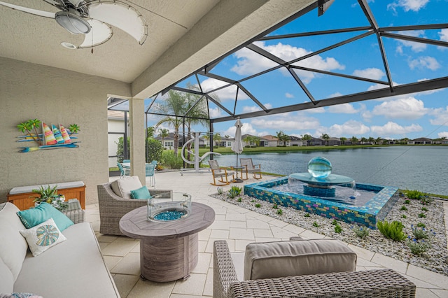 view of patio featuring an outdoor hangout area, a water view, glass enclosure, and ceiling fan